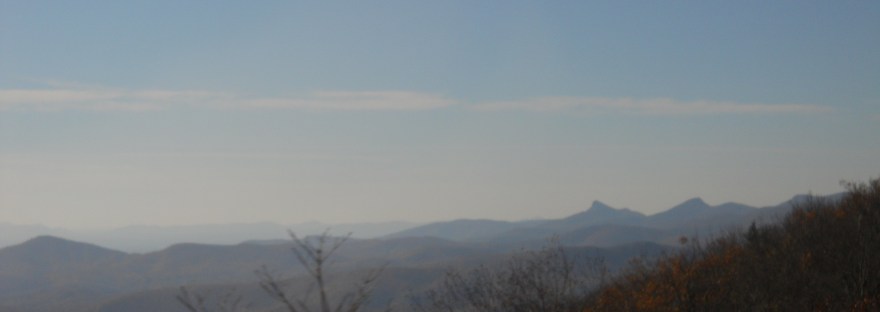 Shadowy mountains brood under a dim sky.